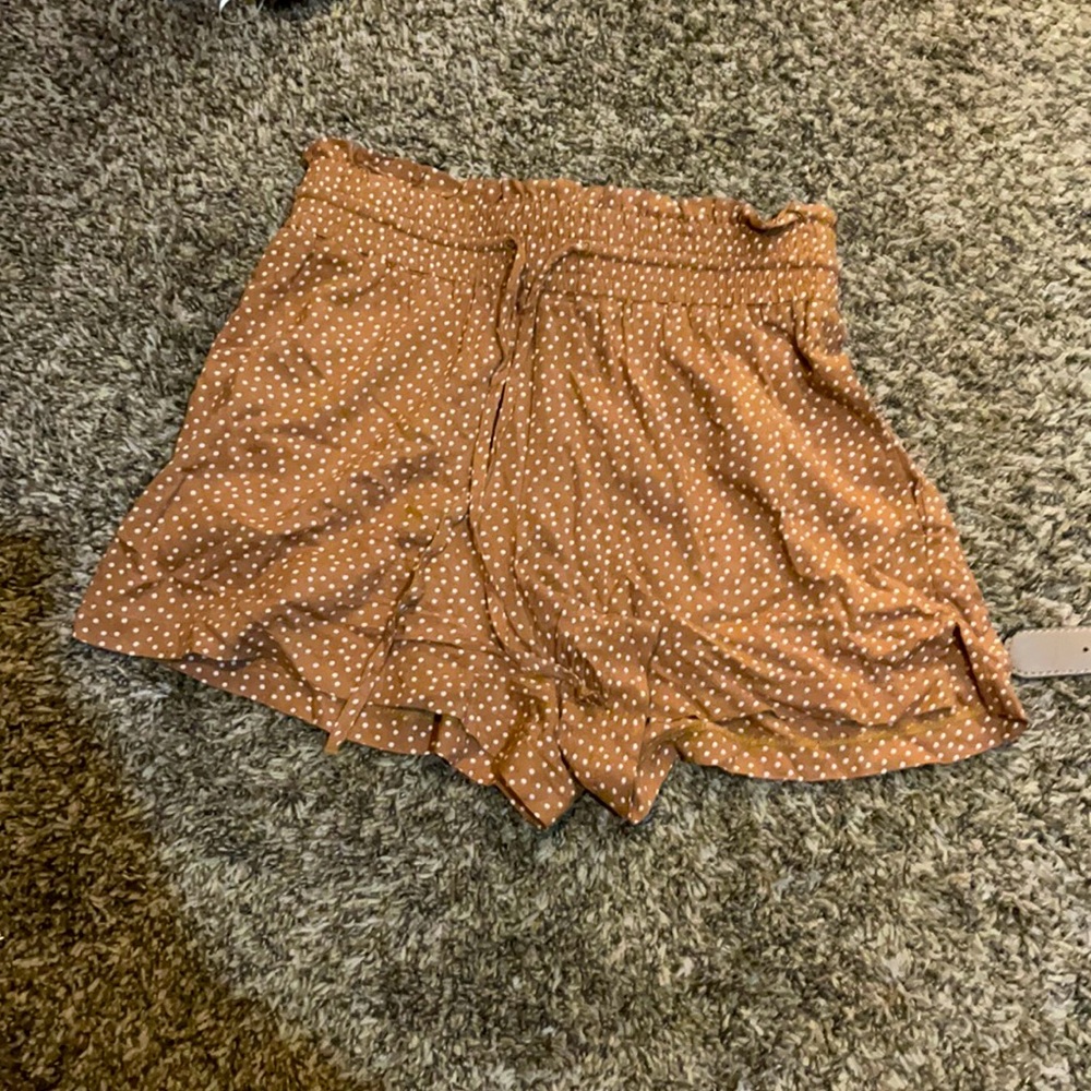 Brown shorts with white polka dots.